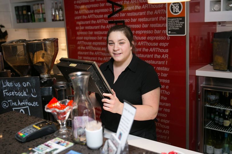 cafe worker behind coutner